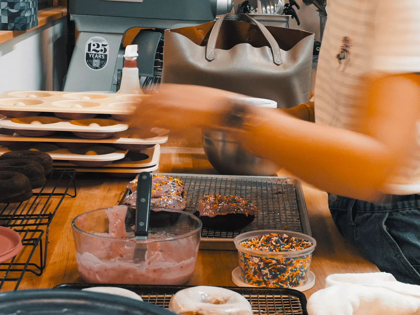 Photo of rows of books in a library with marble busts.