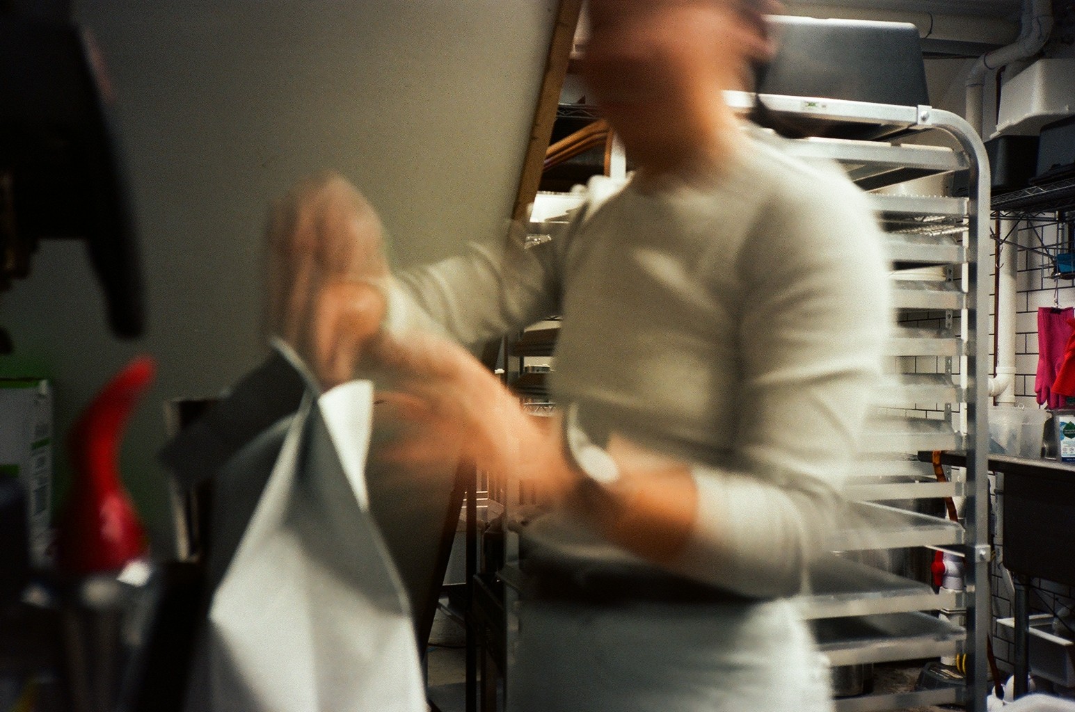 Photo of rows of books in a library with marble busts.