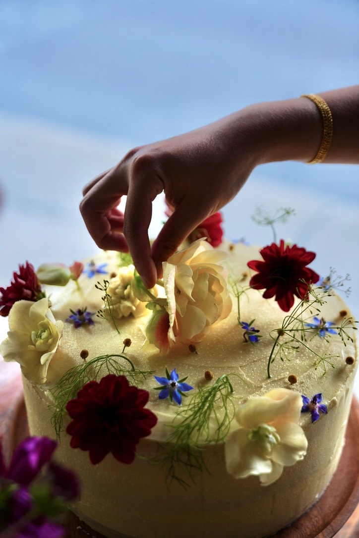 Photo of rows of books in a library with marble busts.