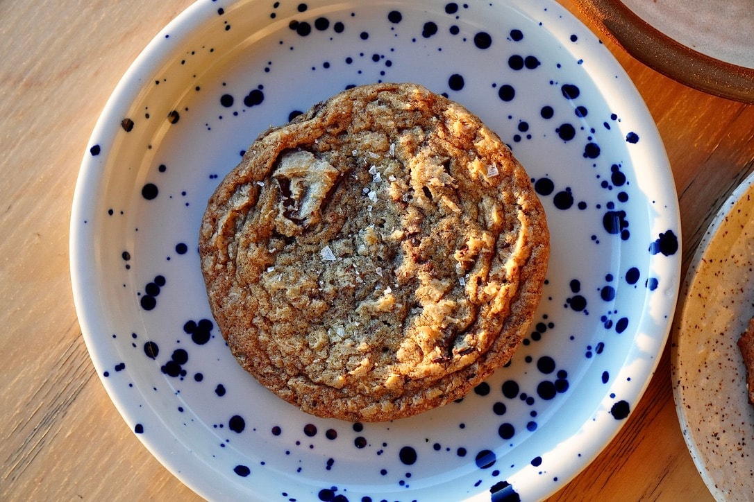 Photo of rows of books in a library with marble busts.