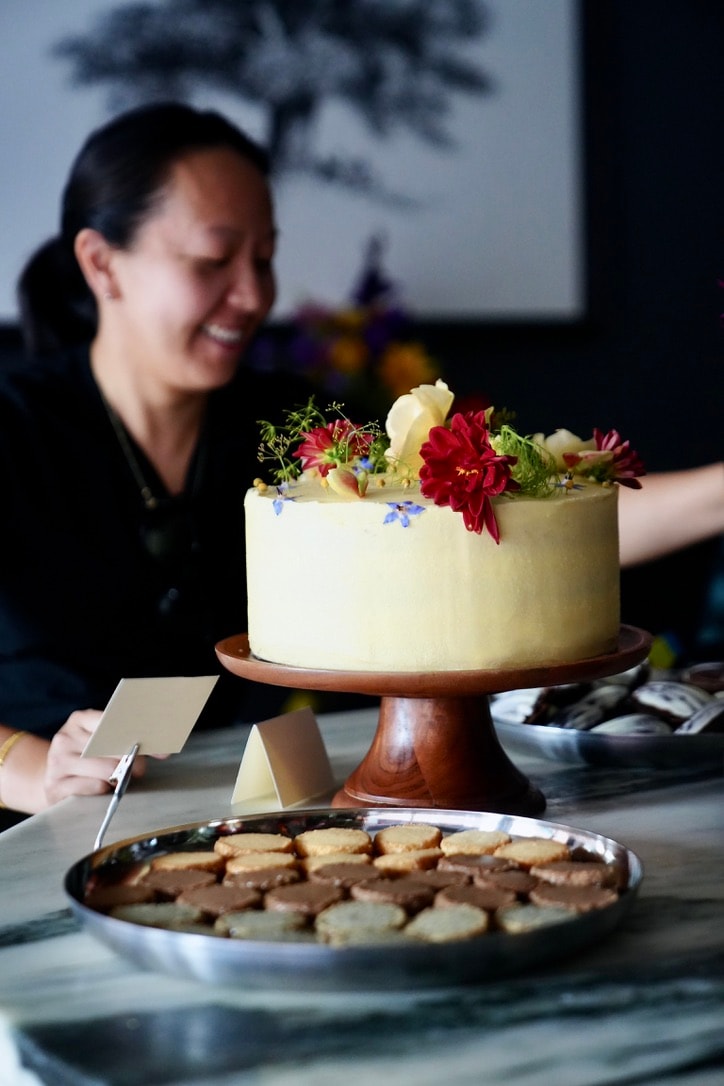 Photo of rows of books in a library with marble busts.