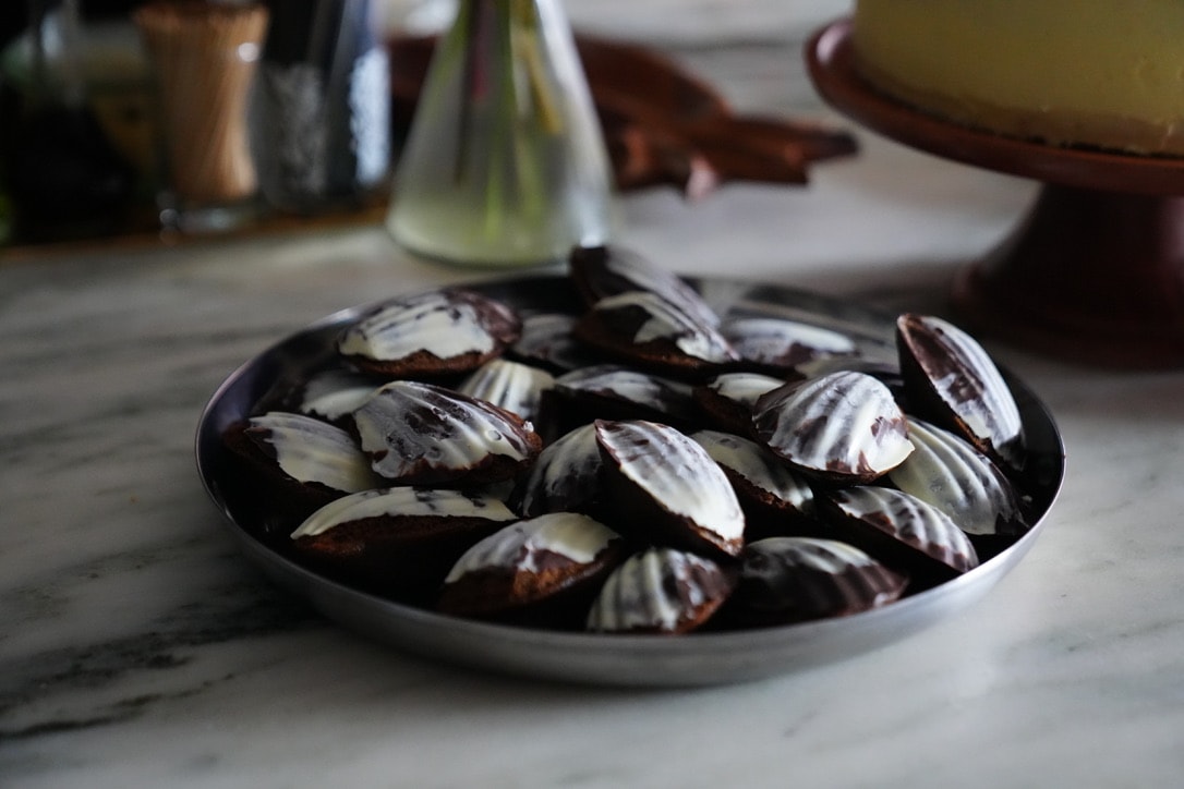 Photo of rows of books in a library with marble busts.